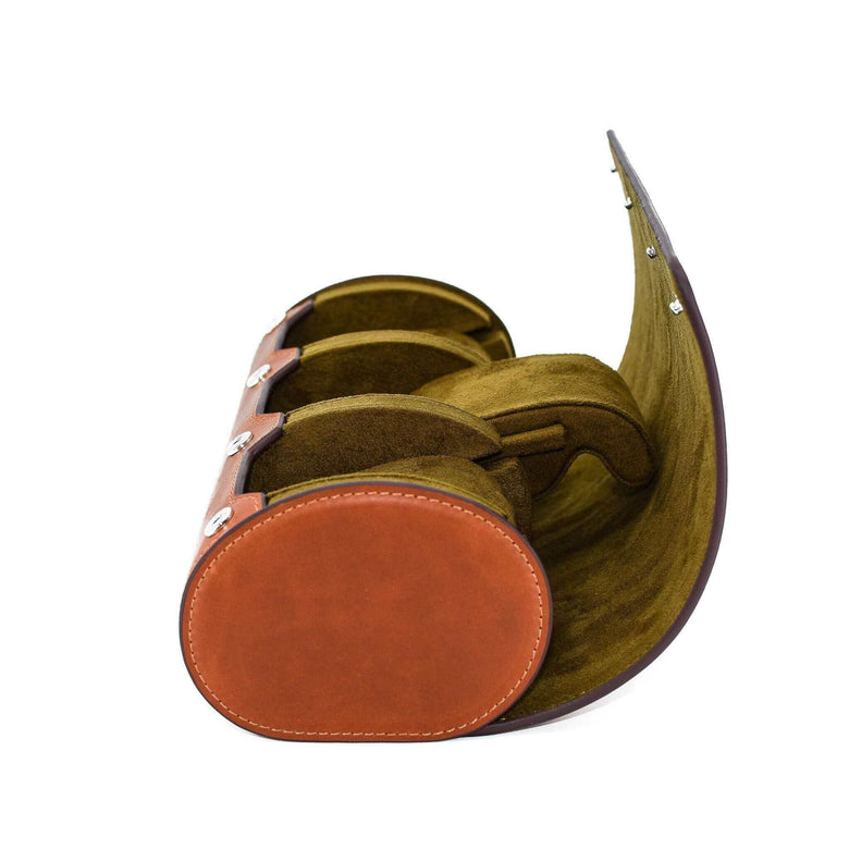 A side view including the compressible watch pillow of Luxury Watch Roll's triple slot, vintage brown leather watch roll for three watch storage.